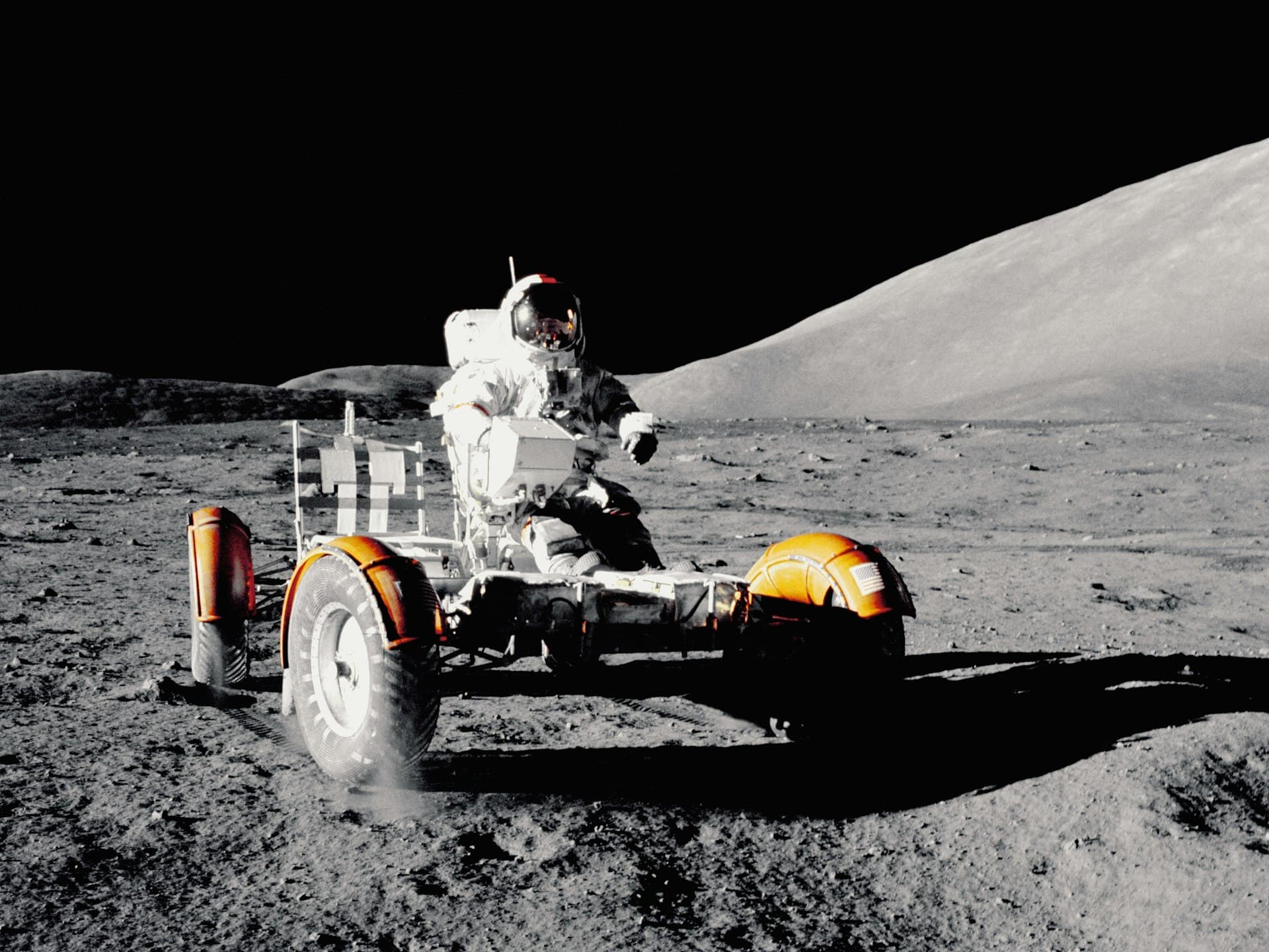 Astronaut driving the lunar rover on the Moon's surface